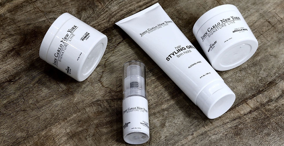 John Carlo New York styling products arranged on a natural wood surface